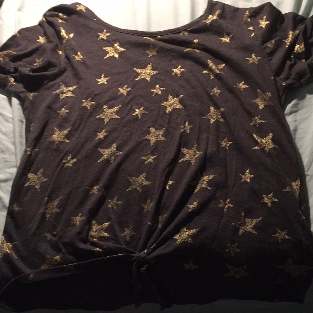 A grey shirt with gold stars